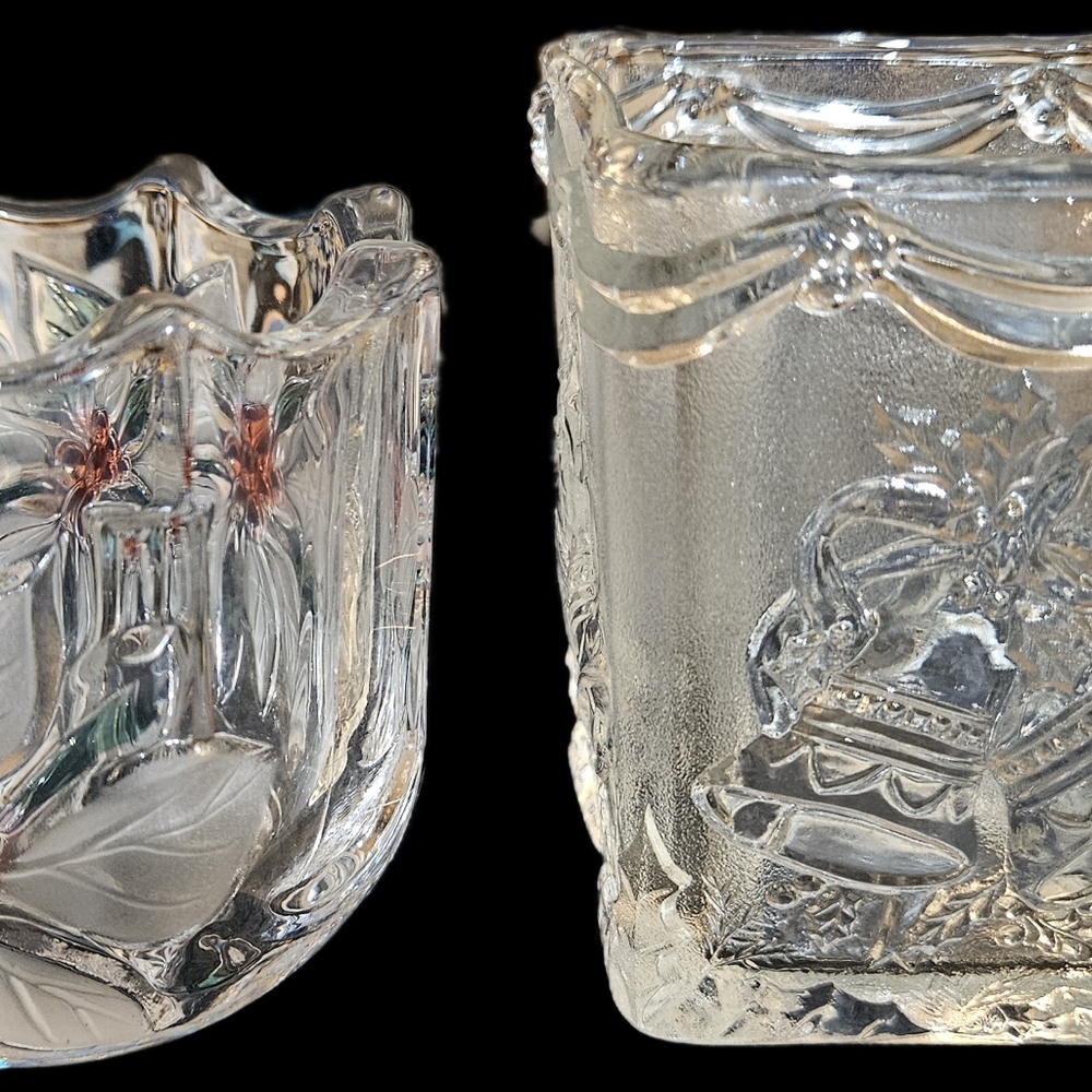 Two Christmas candle holders, one with red poinsettia design and the other Bells
